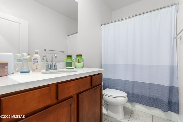 bathroom featuring tile patterned flooring, vanity, and toilet