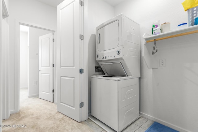 washroom with stacked washer and dryer and light colored carpet