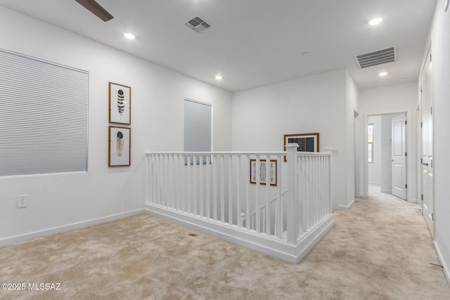 hallway with light carpet