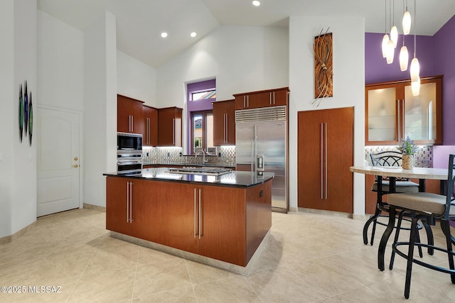 kitchen with built in appliances, high vaulted ceiling, decorative backsplash, a center island, and dark countertops