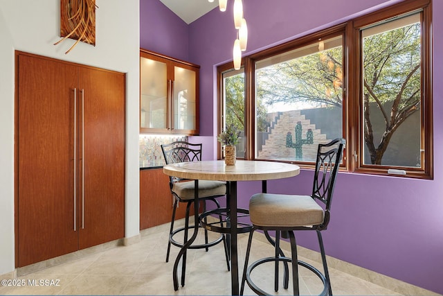 dining space featuring light tile patterned flooring