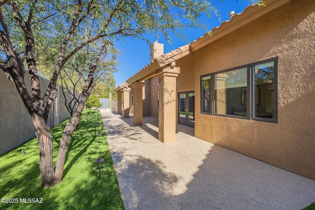 view of yard featuring a fenced backyard, french doors, and a patio