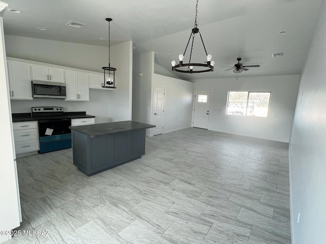 kitchen featuring appliances with stainless steel finishes, decorative light fixtures, a center island, and white cabinets