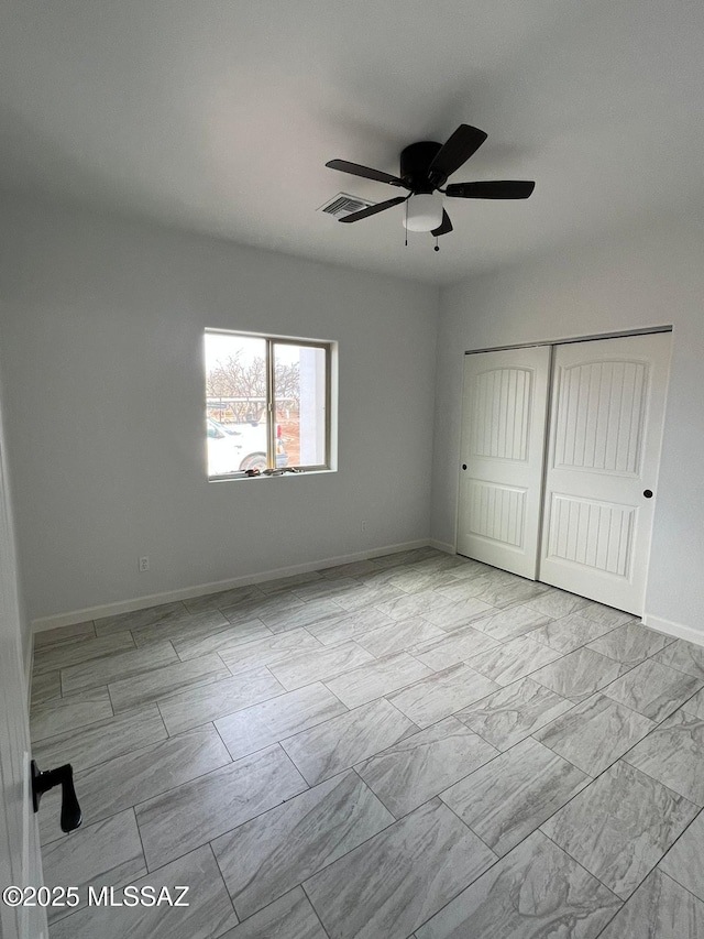 unfurnished bedroom with a closet and ceiling fan