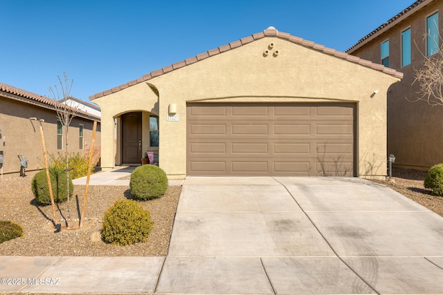 mediterranean / spanish-style house with a garage