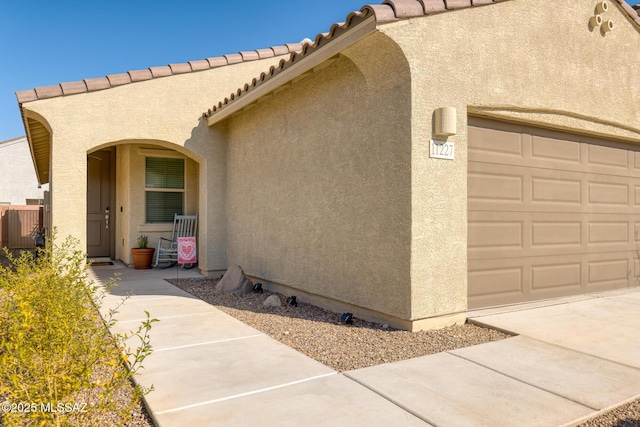 view of exterior entry with a garage