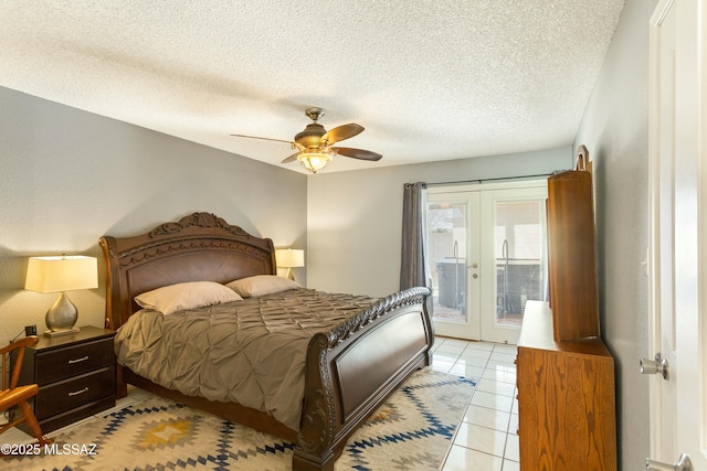 tiled bedroom featuring ceiling fan, access to outside, a textured ceiling, and french doors