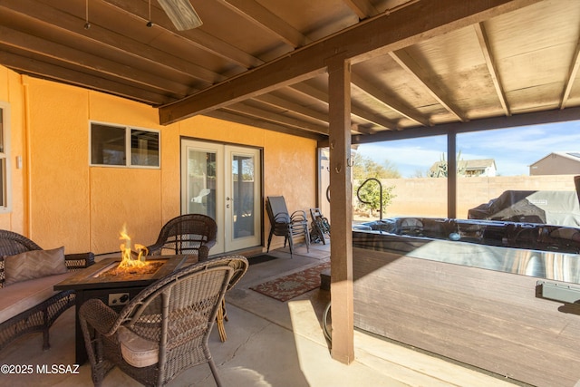 view of patio / terrace with french doors and an outdoor fire pit