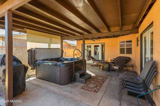 view of patio / terrace featuring ceiling fan and a hot tub