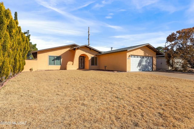 ranch-style home featuring a garage and a front yard