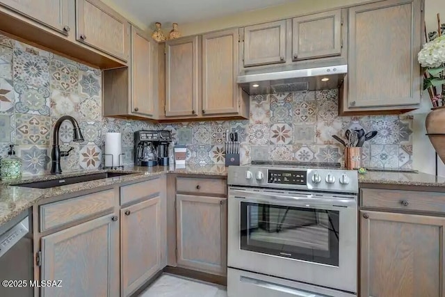 kitchen featuring sink, stainless steel appliances, light stone counters, tasteful backsplash, and light brown cabinetry