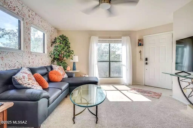 living room with plenty of natural light, light colored carpet, and ceiling fan