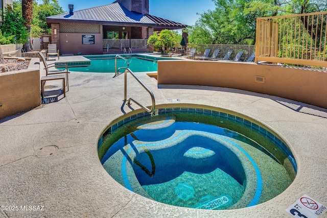 view of swimming pool with a community hot tub and a patio