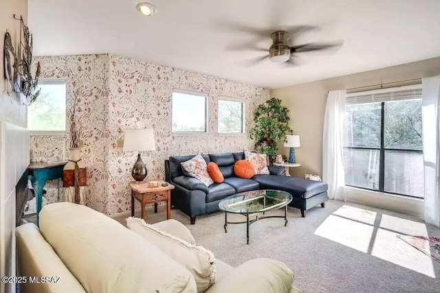 living room featuring a healthy amount of sunlight, light carpet, and ceiling fan