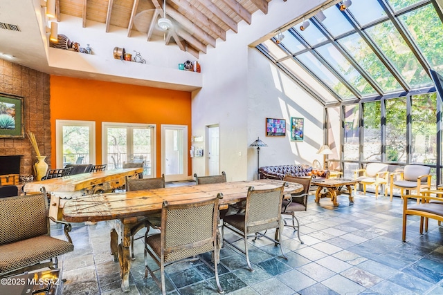 interior space with a wealth of natural light, wood ceiling, and beam ceiling