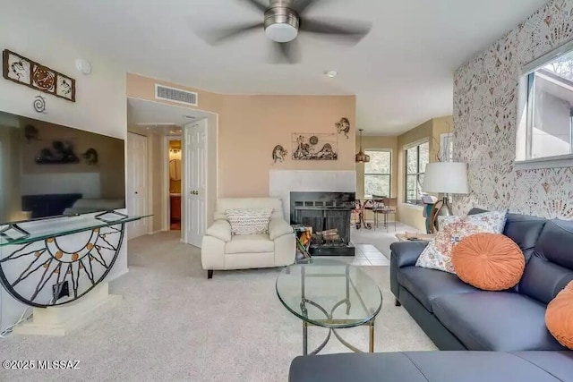 carpeted living room featuring ceiling fan