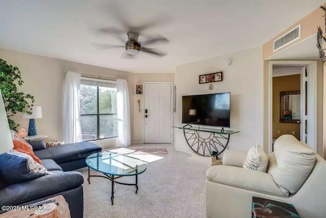 carpeted living room featuring ceiling fan
