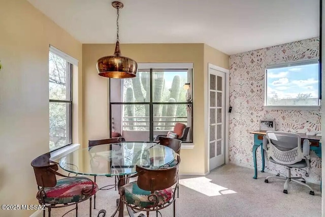 dining area featuring french doors and carpet flooring