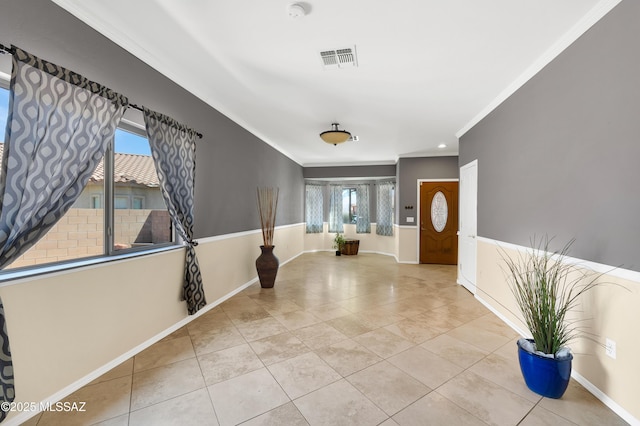 tiled foyer with ornamental molding