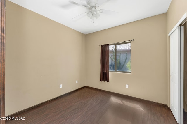 unfurnished room with ceiling fan and dark hardwood / wood-style flooring