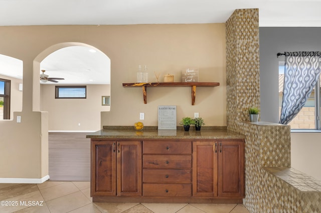 interior space featuring ceiling fan and light tile patterned floors