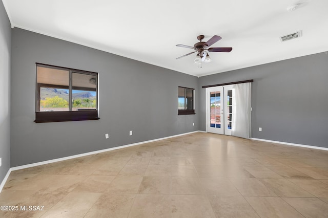 unfurnished room featuring light tile patterned flooring, plenty of natural light, ceiling fan, and french doors