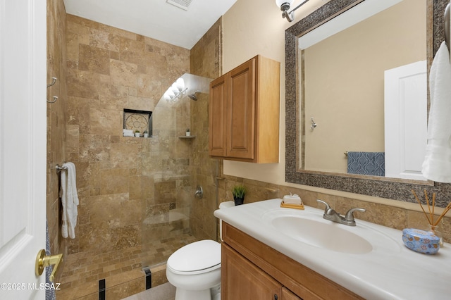 bathroom with vanity, a shower with shower door, and toilet