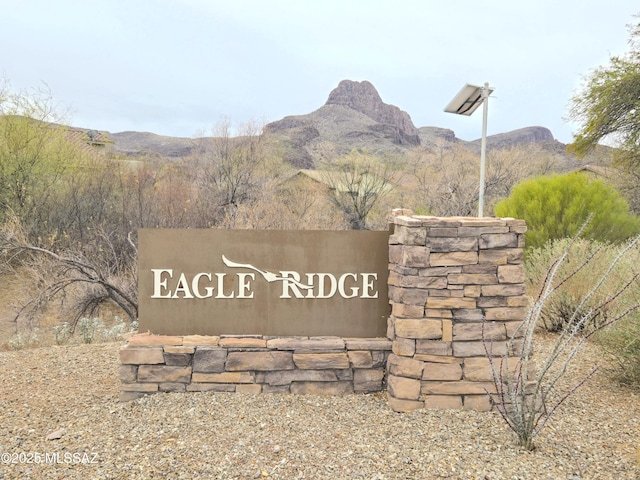 community / neighborhood sign with a mountain view