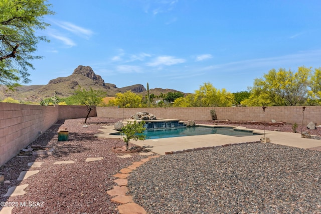 view of yard featuring a fenced in pool and a mountain view