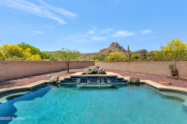 view of swimming pool with a mountain view