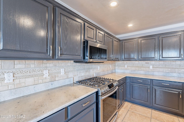 kitchen with ornamental molding, appliances with stainless steel finishes, light tile patterned floors, and decorative backsplash