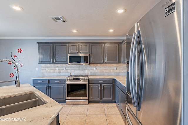 kitchen featuring gray cabinets, tasteful backsplash, sink, light tile patterned floors, and stainless steel appliances