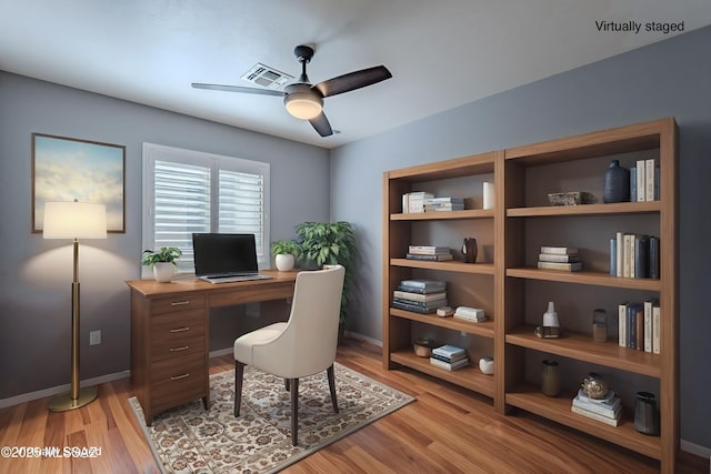 office with ceiling fan and light hardwood / wood-style flooring