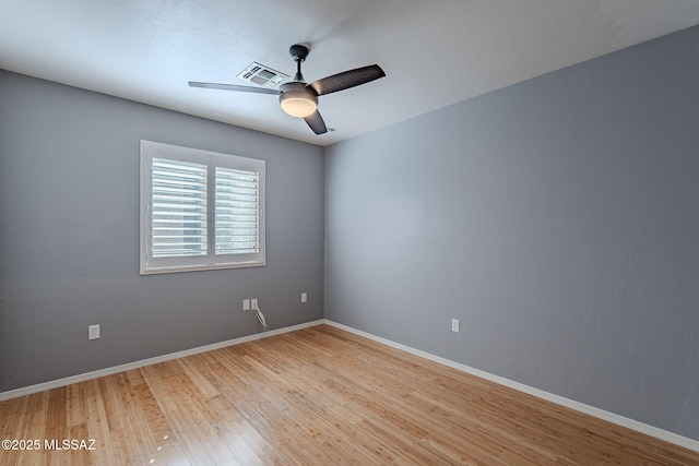 spare room featuring light hardwood / wood-style flooring and ceiling fan