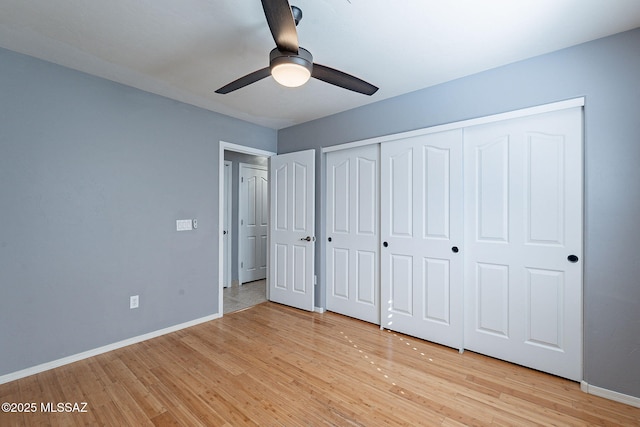 unfurnished bedroom featuring a closet, ceiling fan, and light wood-type flooring