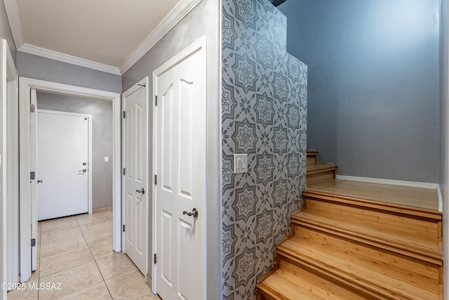 staircase featuring crown molding and tile patterned floors