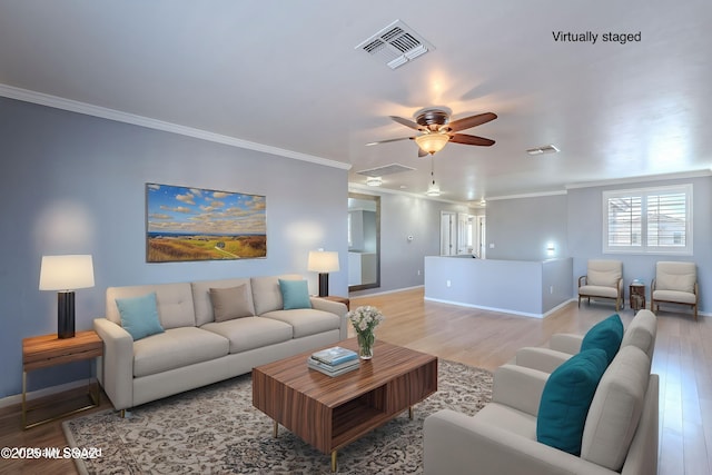 living room featuring light hardwood / wood-style flooring, ornamental molding, and ceiling fan