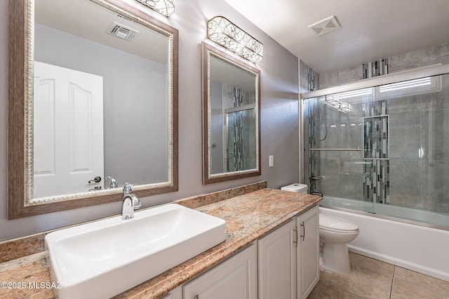 full bathroom with vanity, tile patterned floors, enclosed tub / shower combo, and toilet