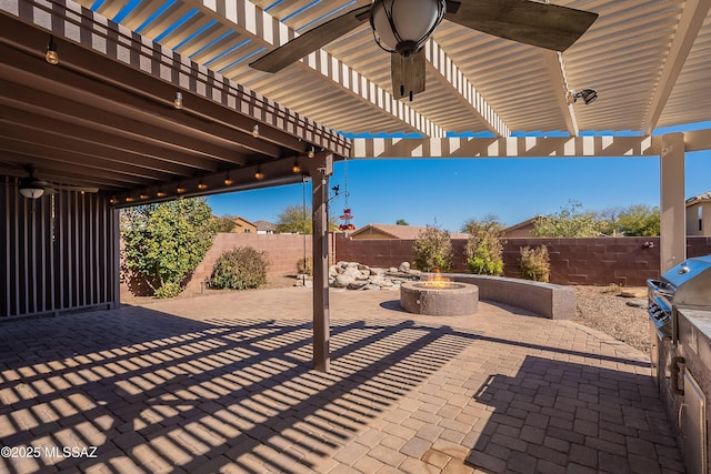 view of patio / terrace featuring a grill, an outdoor kitchen, a pergola, and a fire pit