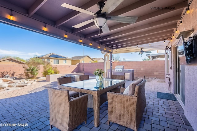 view of patio featuring an outdoor kitchen, ceiling fan, and a grill