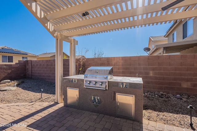 view of patio with an outdoor kitchen, a grill, and a pergola