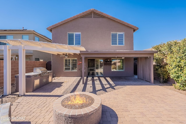 rear view of property with a patio, a fire pit, area for grilling, and a pergola