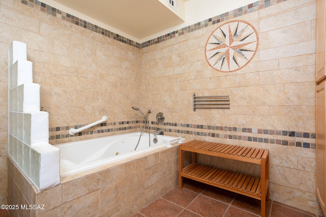 bathroom featuring tile patterned flooring, a jetted tub, and tile walls