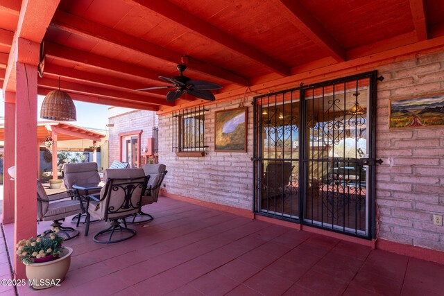 wooden terrace featuring ceiling fan