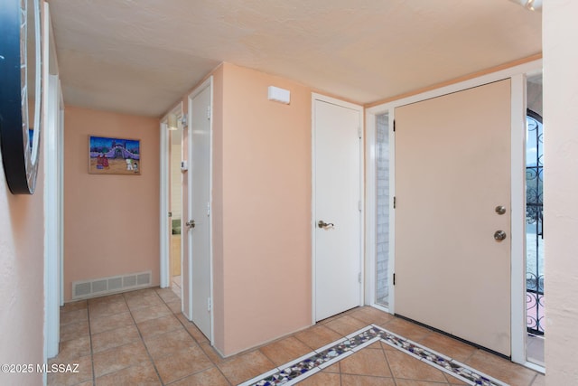 entrance foyer with visible vents and light tile patterned floors