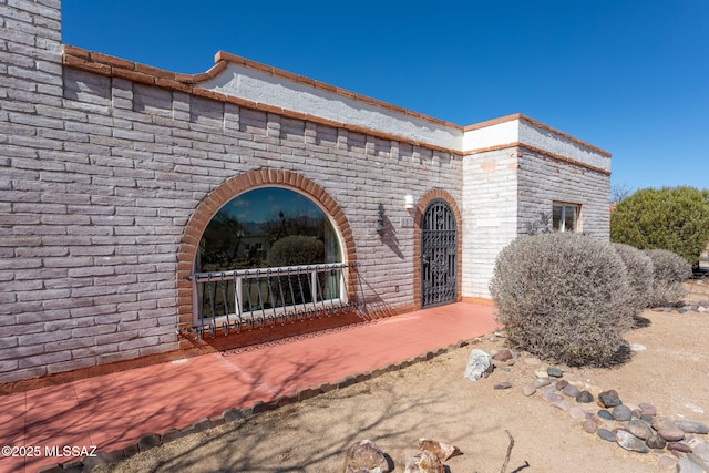 property entrance featuring brick siding