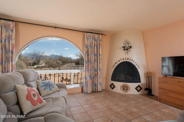 sitting room with a fireplace and light tile patterned floors