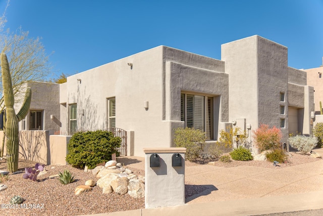 exterior space with fence and stucco siding