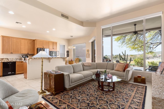 living area featuring light tile patterned floors, visible vents, a ceiling fan, and recessed lighting