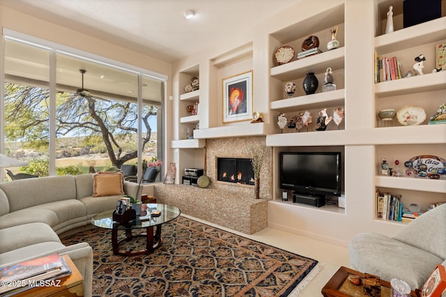 living room with built in shelves and a premium fireplace